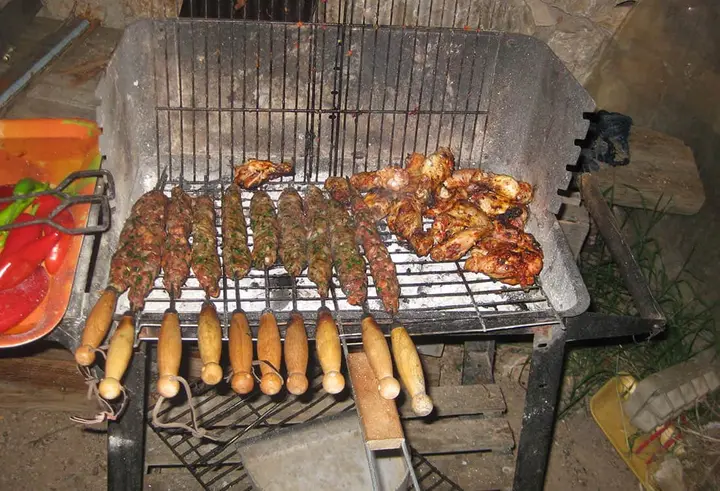 Skewers, chicken and corn cobs on a charcoal grill