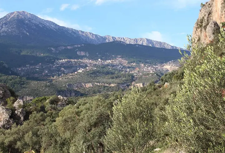 View over a valley with a village and a mountain range