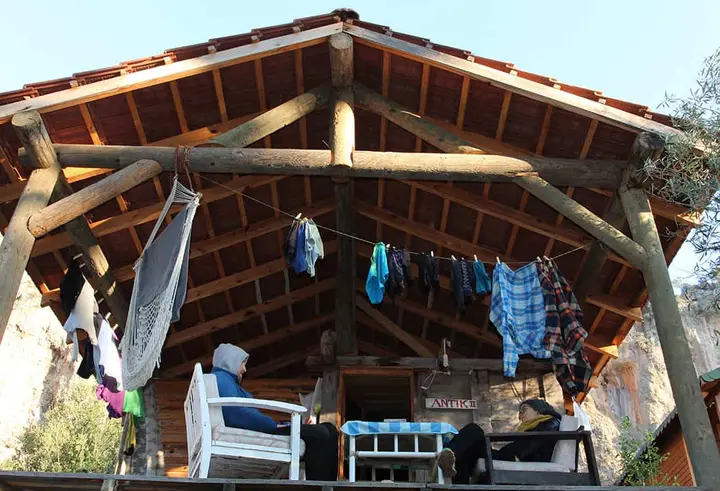 Covered wooden terrace with laundry hanging to dry