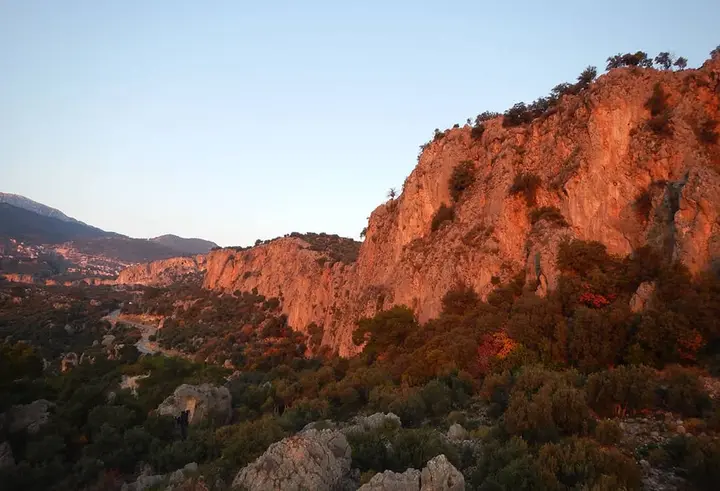 Cliff edge and valley in warm evening light
